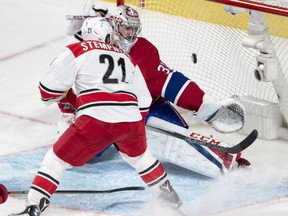 Lee Stempniak of the Carolina Hurricanes redirects a shot past Carey Price of the Montreal Canadiens during NHL action Thursday night in Montreal. The Hurricanes extended their unbeaten streak to nine games and moved to within five points of the final playoff spot with a 4-1 victory over the struggling Canadiens.