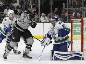 Jarome Iginla of the Kings watches the puck deflect off Vancouver Canucks goalie Ryan Miller during the second period of their game in Los Angeles on Saturday night.