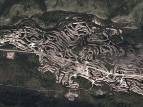 Satellite image of the eastern edge of Dawson City, Yukon. The cylindrical gray piles are dredge tailings that the municipal is looking to protect as a historic site.