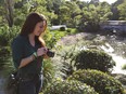 Casey Anthony takes photos Feb. 11, 2017, at the Morikami Gardens in Delray Beach, Fla. Anthony knows that much of the world believes she killed her 2-year-old daughter, despite her acquittal. But nearly nine years later, she insists she doesn't know how the last hours of Caylee's life unfolded.