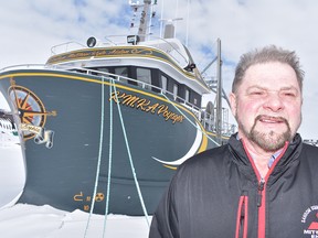 Theodore Genge in front of the KMKA Voyager in Anchor Point.