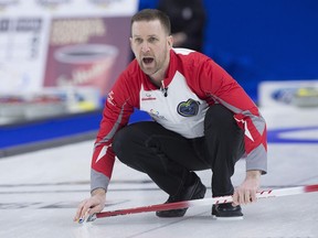 Brad Gushue curls at the Brier on March 10.