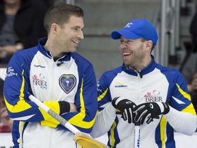 British Columbia skip John Morris, left, and third Jim Cotter share a laugh during their game against Newfoundland and Labrador at the Tim Hortons Brier at Mile One Centre in St. John's on Wednesday.