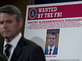 A wanted poster for Dmitry Aleksandrovich Dokuchaev sits on display during a news conference at the Department of Justice in Washington, D.C., U.S., on Wednesday, March 15, 2017.