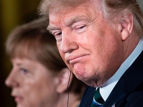 U.S. President Donald Trump listens to German Chancellor Angela Merkel during a press conference at the White House on March 17, 2017.