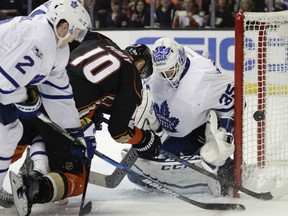 Toronto Maple Leafs'  goaltender Curtis McElhinney is able to thwart the scoring attempt of Anaheim Ducks' Corey Perry from close in during NHL action Friday night in Anaheim. It was a rough night for McElhinney and the Leafs as they lost 5-2 to extend their winning streak to five straight games.