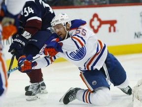 Mark Letestu of the Edmonton Oilers seems all bent out of shape as he tries to check Carl Soderberg of the Colorado Avalanche in NHL action Thursday night in Denver. The Oilers had five third-period goals en route to a 7-4 victory over the NHL sadsacks.