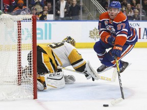 Connor McDavid of the Edmonton Oilers tries to dispy-doodle around Pittsburgh Penguins' goaltender Marc-Andre Fleury during NHL action Friday night in Edmonton. McDavid had a goal but the Penguins prevailed 3-2 in a shootout.