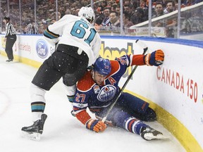 Edmonton Oilers Milan Lucic falls into the boards while trying to check San Jose Sharks' defenceman Justin Braun during NHL action Thursday night in Edmonton. The Oilers were 3-2 winners as they continue to dominate Pacific Division teams.