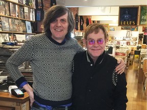 David Jones, owner of Vinyl Records poses for a photo with Elton John in his Vancouver store in this handout photo on Thursday, March 9, 2017.
