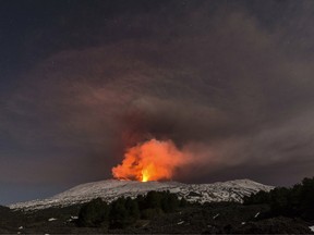 Snow-covered Mount Etna, Europe's most active volcano, spews lava during an eruption in the early hours of March 16, 2017.