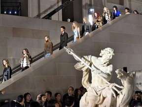 Models descend a staircase in the finale of the Louis Vuitton fall/winter 2017 collection, which took place at the Louvre Museum.