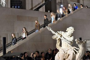 Models descend a staircase in the finale of the Louis Vuitton fall/winter 2017 collection, which took place at the Louvre Museum.