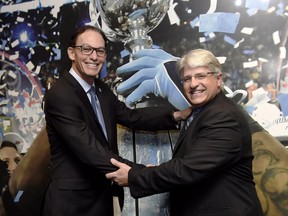 New Toronto Argonauts head coach Marc Trestman, left, and new general manager Jim Popp pose for a photo ahead of a press conference to announce their hirings in Toronto on Feb. 28.