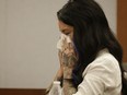 A 2014 file photo og Christine Mackinday, also known as Christy Mack, cries on the witness stand during a preliminary hearing for Jonathan Paul Koppenhaver