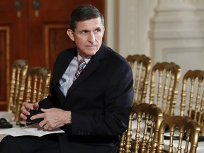 Former National Security Adviser Michael Flynn sits in the East Room of the White House in Washington, Feb. 10, 2017.
