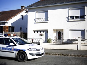 This Tuesday, Feb. 28, photo shows a police car parked outside the house belonging to the missing Troadec family in Orvault, near Nantes, western France.