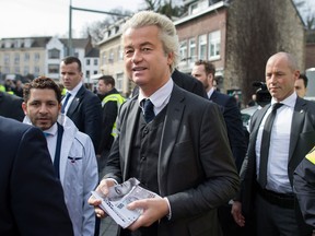 Geert Wilders, leader of the Dutch Freedom Party, carries election leaflets while campaigning in Valkenburg, Netherlands, on Saturday, March 11, 2017.