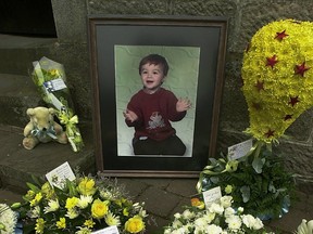 Alistair Grimason's picture is shown with floral tributes at the entrance to The Old Parish Church on July 17, 2003 in East Kilbride, Scotland.