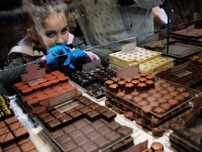 At Choco-Story New York, there are chocolate tastings led by a professional chocolatier. In a 2007 file photo, a girl looks over chocolates in a case at Jacques Torres Chocolate in New York City.
