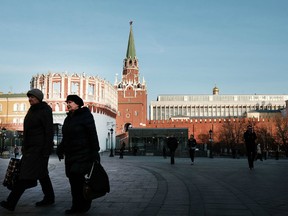 Women pass by the entrance to the Kremlin on March 10, 2017 in Moscow, Russia.