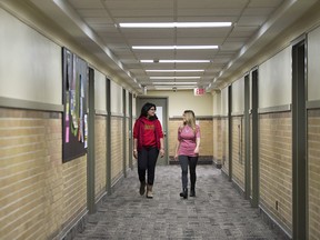 Manali Kolekar, 2nd year biological sciences student, left, and Jasmin Dalton, Residence Life Manager, walk through Johnston Hall residences at the University of Guelph in Guelph, Ontario on Friday March 24, 2017.