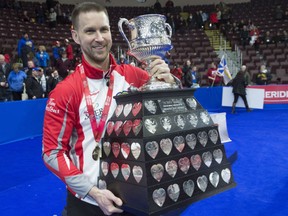 Brad Gushue holds the Brier trophy after his rink defeated Team Canada, skipped by Kevin Koe, on March 12.