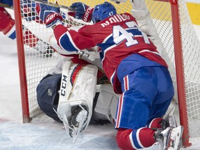 Alexander Radulov, right, of the Montreal Canadiens runs roughshod over Florida Panthers' goaltender Reto Berra during NHL action Thursday night in Montreal. The Canadiens won 6-2 to clinch a playoff position for the fourth time in five seasons.