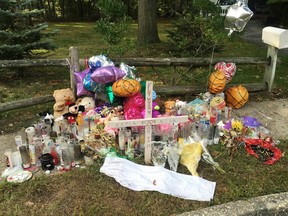 In this Sept. 27, 2016 file photo, a memorial to best friends Nisa Mickens and Kayla Cueva is seen near the spot where their bodies were found in Brentwood, N.Y.