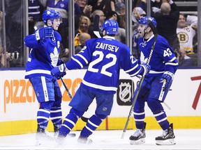 Toronto Maple Leafs centre Tyler Bozak (left) celebrates his goal against the Boston Bruins with teammates Nikita Zaitsev (centre) and Nazem Kadri on March 20.