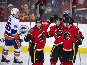 Calgary Flames forward T.J. Brodie, centre, celebrates his goal with teammates Matt Stajan, second from left, and Dougie Hamilton against the New York Islanders on March 5.