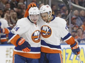 New York Islanders' Josh Ho-Sang, right, celebrates with teammate Thomas Hickey after scoring his first NHL goal against the Oilers during their game Tuesday night in Edmonton.