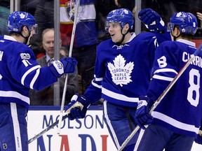 Auston Matthews celebrates his goal with Maple Leafs teammates Zach Hyman, left, and Connor Carrick during first period action in Toronto on Tuesday night. Matthews' goal broke Wendell Clark's rookie goal record.