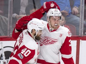 Detroit Red Wings' Anthony Mantha, right, celebrates with teammate Henrik Zetterberg after scoring the winning goal in overtime in Montreal on Tuesday night.