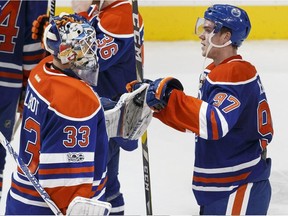 Cam Talbot (left) and Connor McDavid bump fists at the end of an Edmonton Oilers win.