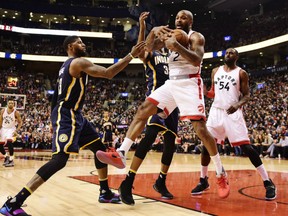 Toronto Raptors forward P.J. Tucker (2) grabs a rebound in front of Indiana Pacers forward Paul George (13) and Pacers centre Myles Turner (33) in Toronto on Sunday, March 19, 2017.