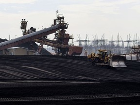 A bulldozer smooths out a pile of coal at the American Electric Power Mountaineer coal plant in Letart, West Virginia, U.S., on March 9, 2016