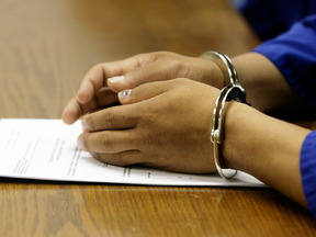 A detainee at an Immigration and Refugee Board hearing.