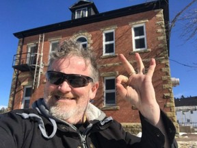 Bill Steele poses in a selfie in front of a former jail in Dorchester, N.B