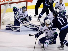 Adam Lowry of the Winnipeg Jets scores past Vancouver Canucks' goaltender Ryan Miller during NHL action Sunday night in Winnipeg. The Jets kept their slight playoff hopes alive with a 2-1 victory.