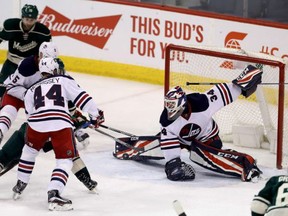 Winnipeg Jets' goaltender Michael Hutchinson makes a game-saving save late against the Minnesota Wild in NHL action Sunday in Minnesota. Hutchinson came in relief of starter Connor Hellebuyck with 13 saves in a 5-4 Jets' victory.