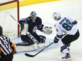 Mikkel Boedker of the San Jose Sharks beats Winnipeg Jets' goaltender Connor Hellebuyck on a breakaway during  NHL action Monday in Winnipeg. The Sharks were 3-2 winners.