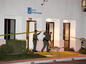 In this Feb. 27, 2017 file photo, Las Vegas Metropolitan Police Department K-9 officers search the Jewish Community Centre of Southern Nevada after an employee received a suspicious phone call