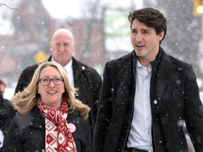 Prime Minister Justin Trudeau walks with Liberal candidate for Ottawa-Vanier Mona Fortier as they meet with constituents in the riding ahead of a by-election, Friday, March 24, 2017.