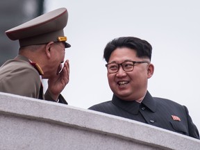 North Korean leader Kim Jong-Un, right, talks to an unidentified soldier on a balcony of the Grand People's Study House during a military parade and mass rally on Kim Il-Sung square in Pyongyang last March.