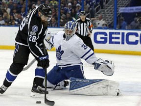 Toronto Maple Leafs' goaltender Frederik Andersen covers the far side as Tampa Bay Lightning Luke Witkowski tries to corral a bouncing puck during NHL action Thursday in Tampa. Andersen posted the shutout with 33 saves.