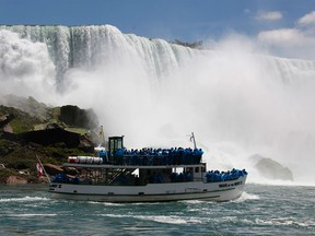 Tourists ride the Maid of the Mist tour boat at the base of the American Falls in Niagara Falls, N.Y., in a June 11, 2010, file photo. The tour boats will open their 2017 season on April 1.
