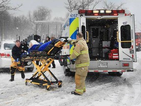 Lakeshore firefighters transport a woman that was pulled from the Puce River Harbour Marina on Tuesday, March 14, 2017.