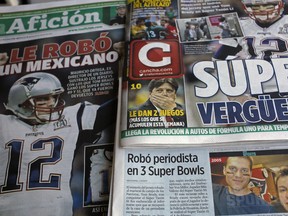 Front pages of Mexican newspapers show headlines and photos about the Tom Brady Superbowl jersey that was allegedly stolen by a Mexican journalist, bottom left on a selfie with Brady, in Mexico City, Mexico March 21, 2017. The headlines read in Spanish "Super embarrassment" top right and "Was stolen by a Mexican," left.