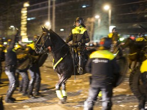 Dutch riot police battle pro Erdogan demonstrators after riots broke out at the Turkish consulate in Rotterdam, Netherlands, Sunday, March 12, 2017